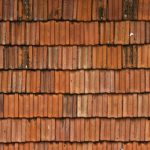 Close-up of a textured orange roof tile surface
